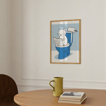 Illustration of a cat reading a newspaper while sitting in a bin, displayed in a frame on a wall.