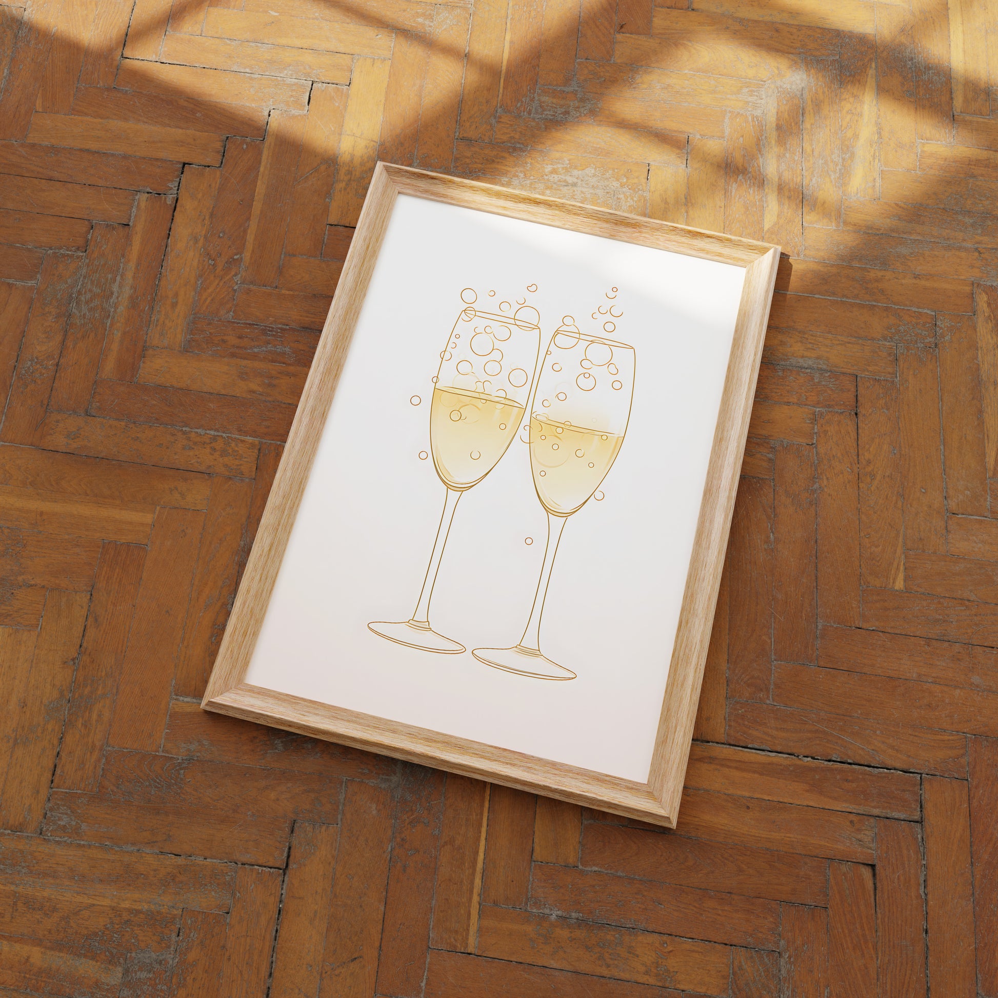 A framed illustration of two champagne glasses toasting on a herringbone wood floor.