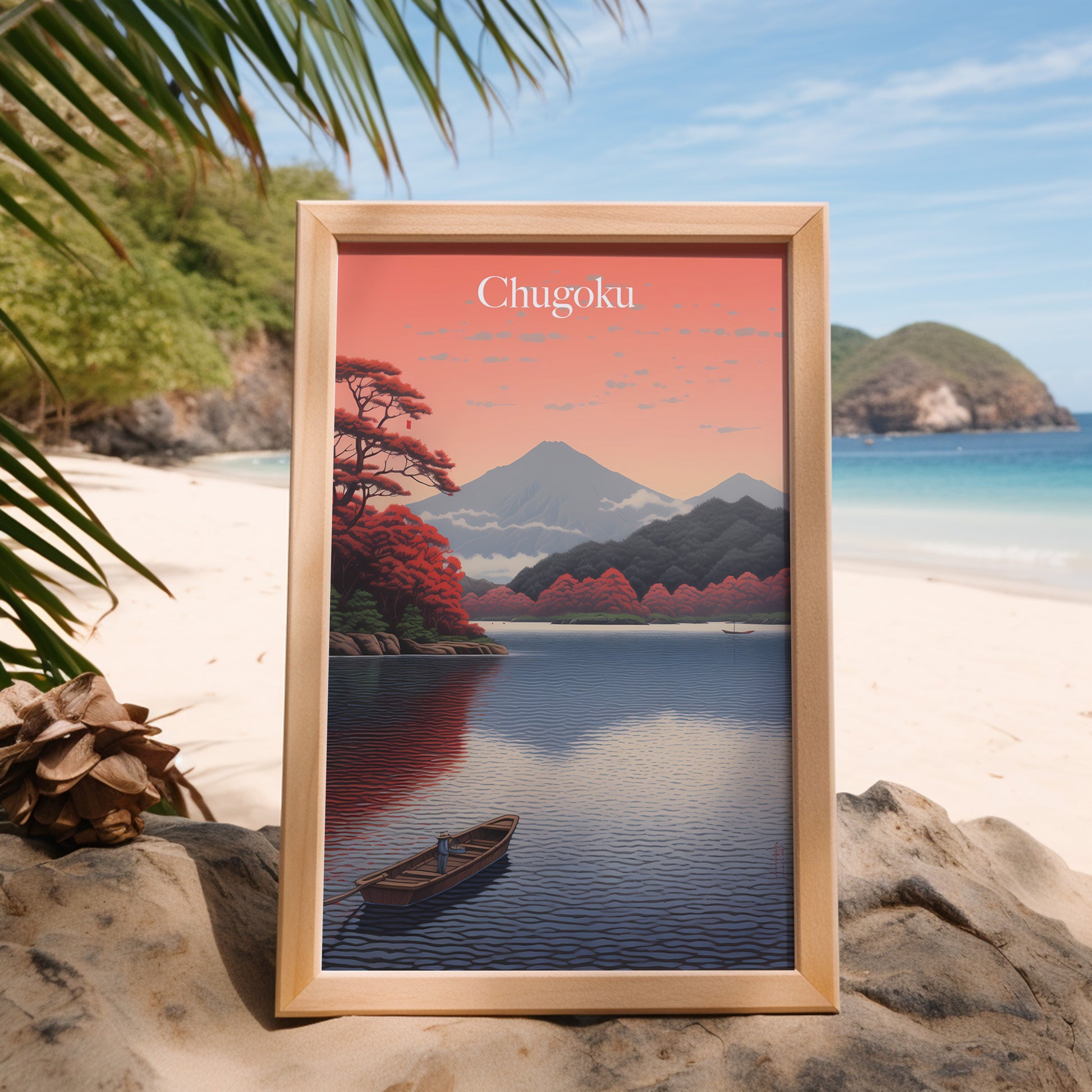 Framed artwork of a mountain landscape with a lake, placed on a sandy beach.