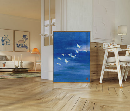 Flying Cranes Over Blue Water Poster