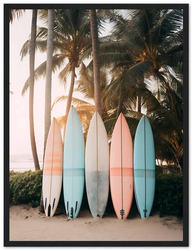 Five colorful surfboards leaning against palm trees on a beach at sunset.