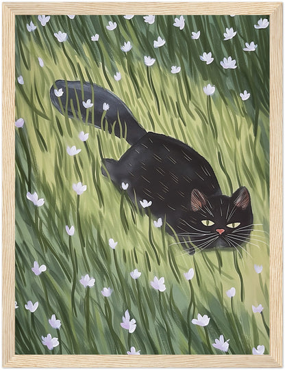 A painting of a black cat walking through a green field with white flowers, framed in wood.