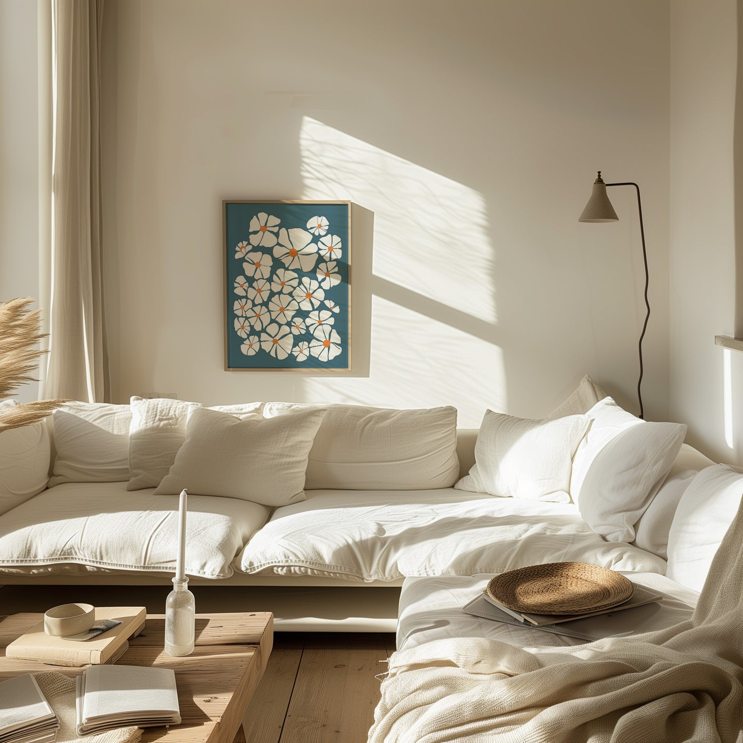 A cozy sunlit living room with a white sofa, wall art, and warm decor.