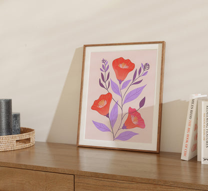 Framed illustration of stylized red flowers and leaves on a wall shelf beside books.