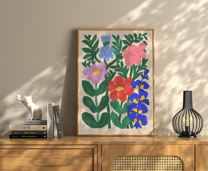 Framed floral art on a wall above a wooden cabinet with books and decor.