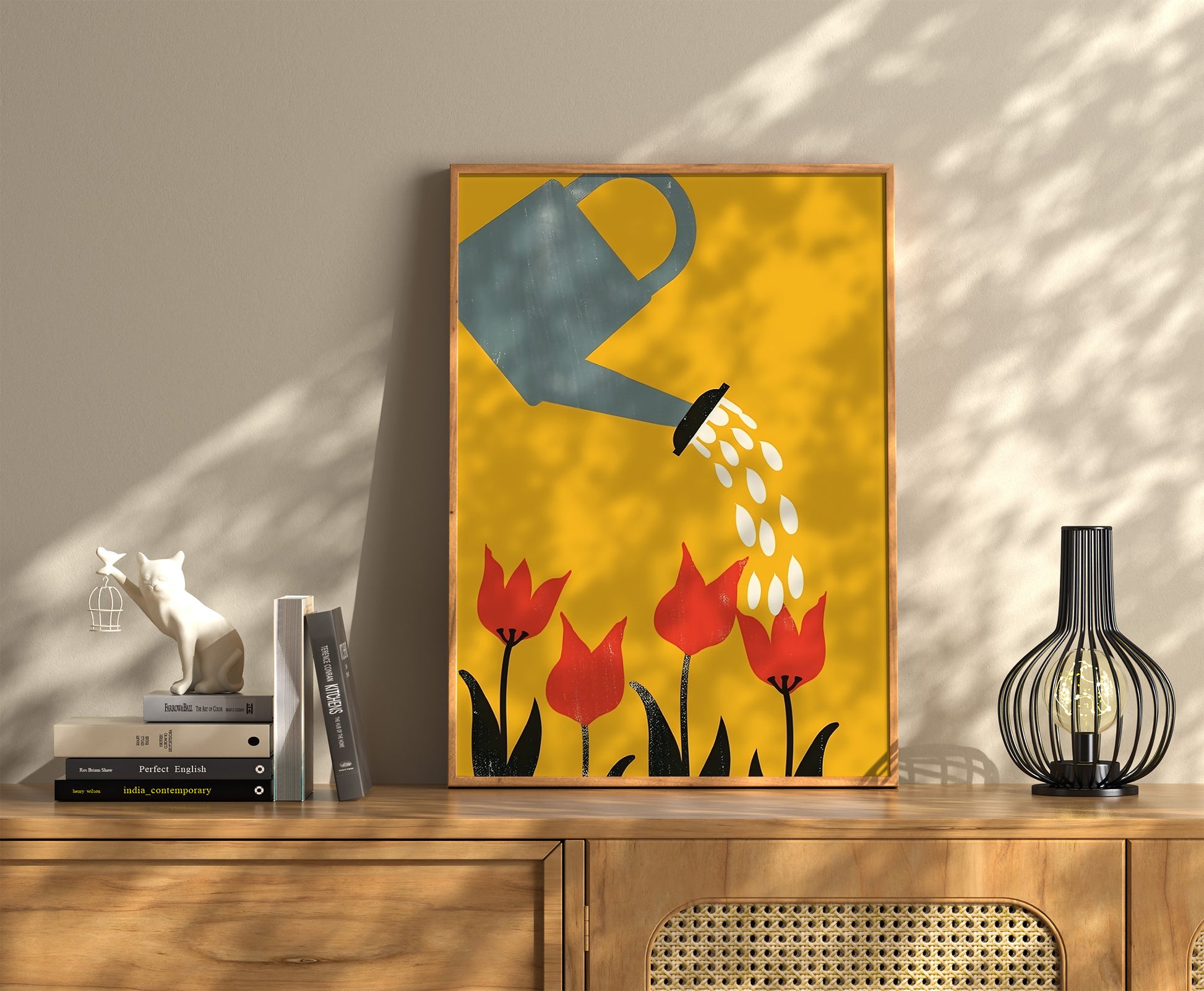 A framed painting of a watering can and red flowers on a sunny background, displayed on a wooden shelf.
