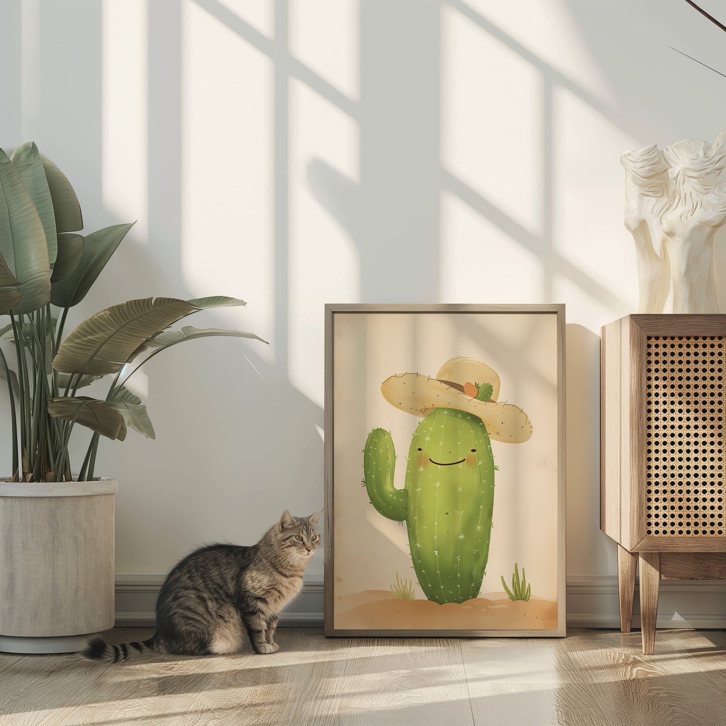 Cat sitting next to a framed picture of a cactus with a hat on the floor inside a house.
