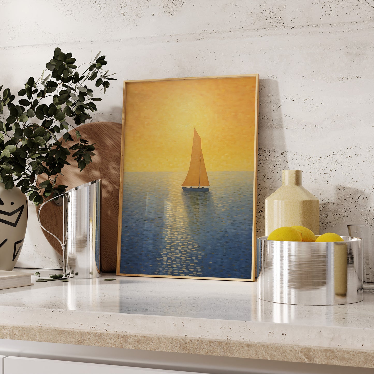 A framed painting of a sailboat at sunset on a kitchen counter, alongside decorative items.