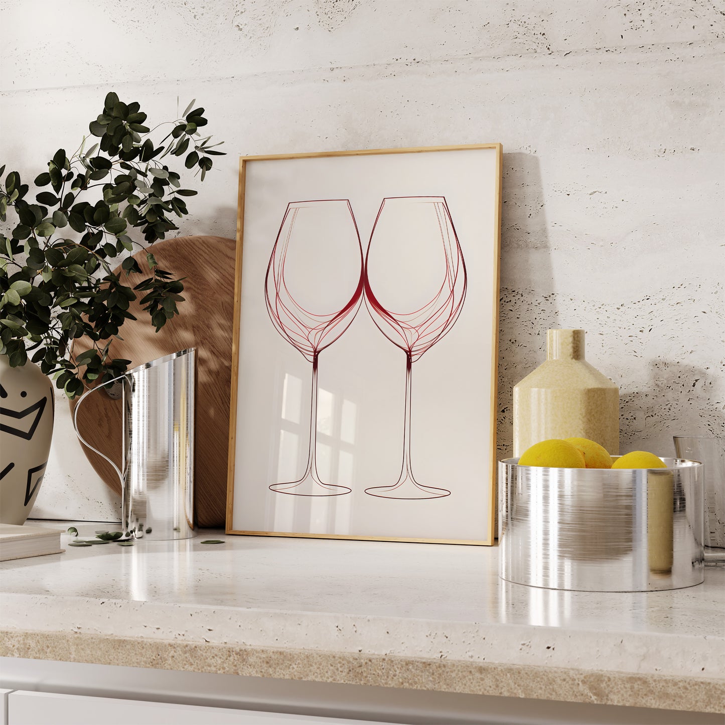 A framed sketch of wine glasses on a kitchen counter with decorative items.