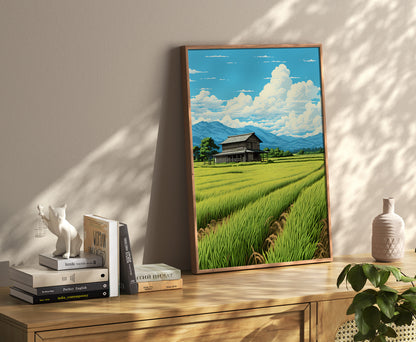 Framed landscape painting with a rice field and a blue sky, on a wooden shelf with books and decor.