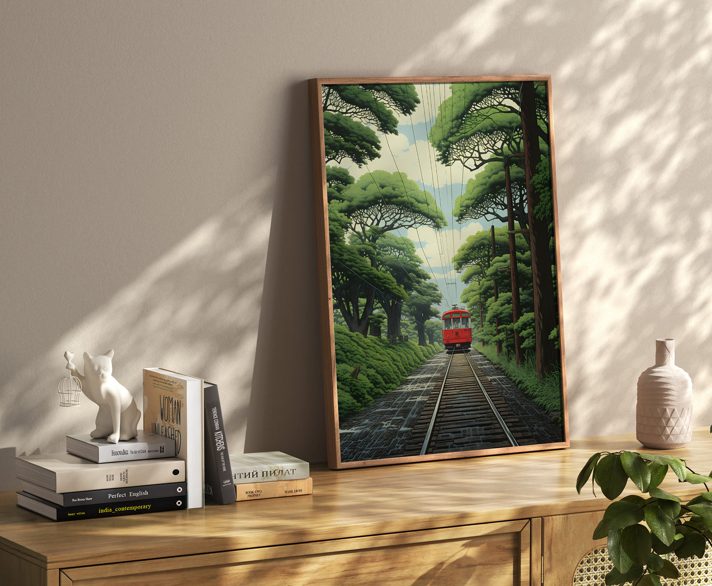 Framed artwork of a train amid greenery on a wall shelf with books and decor.