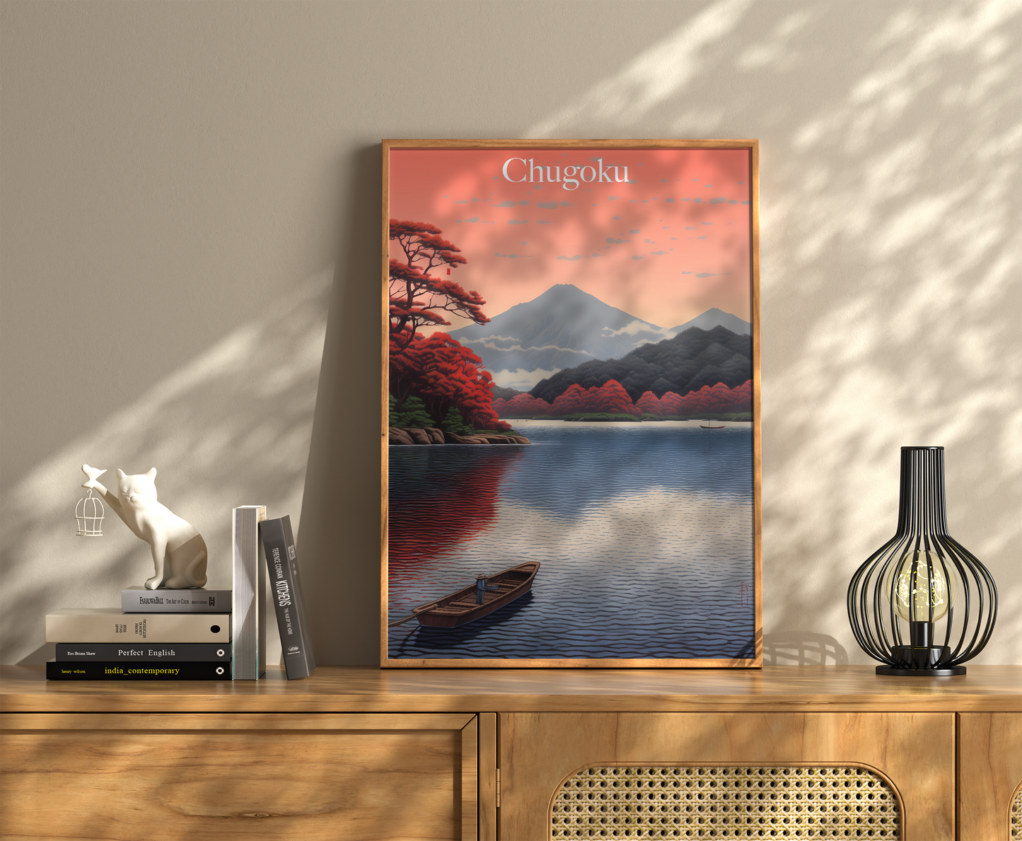 A framed travel poster of Chugoku with a serene lake scene, flanked by books and decorative items.