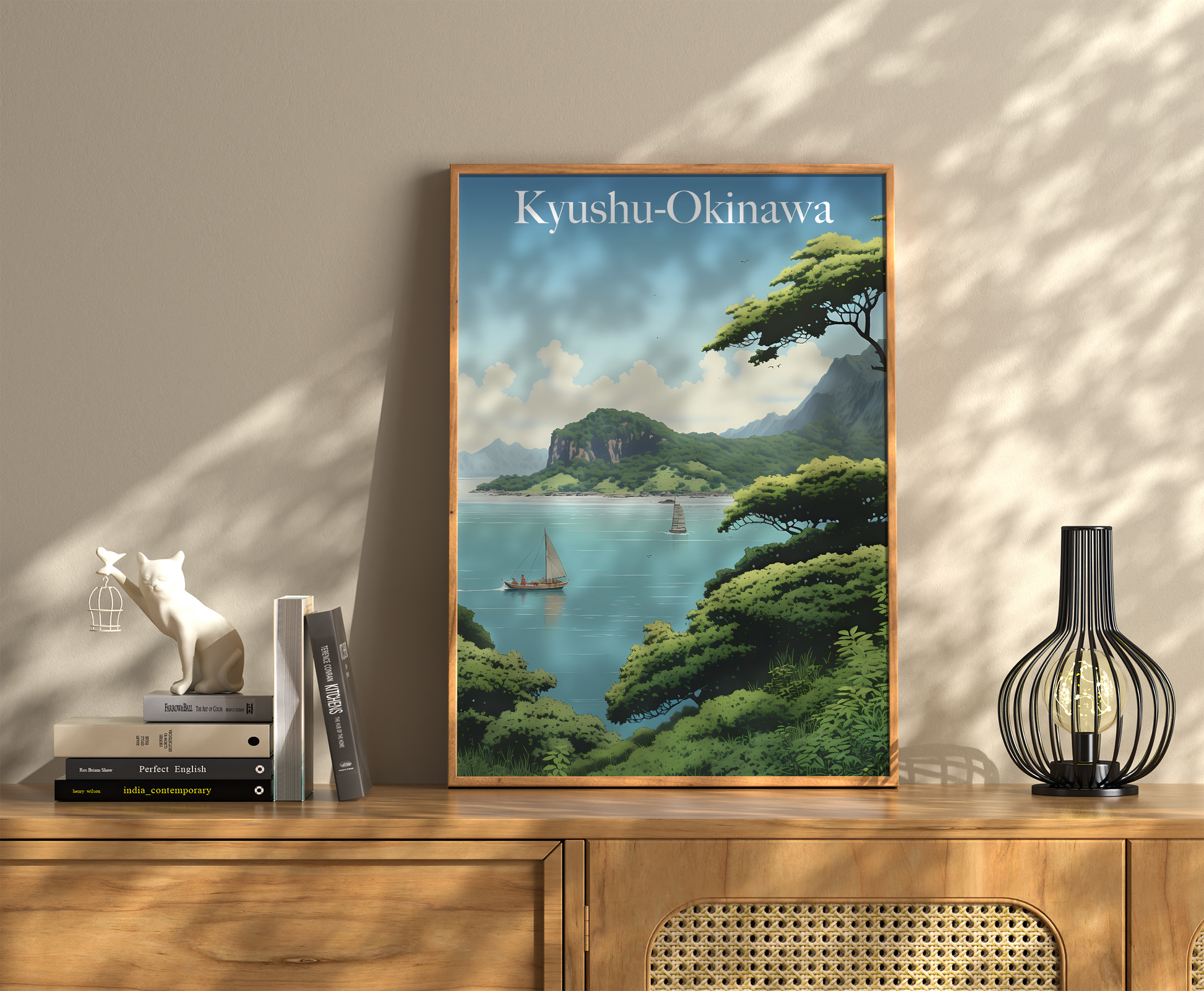 A framed travel poster of Kyushu-Okinawa on a wall above a wooden sideboard with books and a vase.