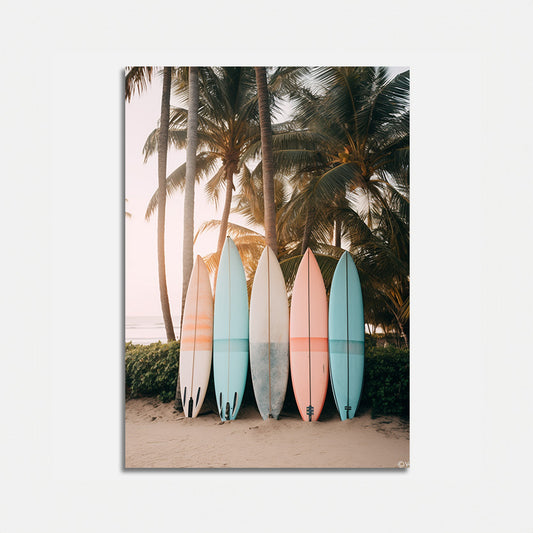 A row of colorful surfboards leaning against palm trees on a beach at sunset.