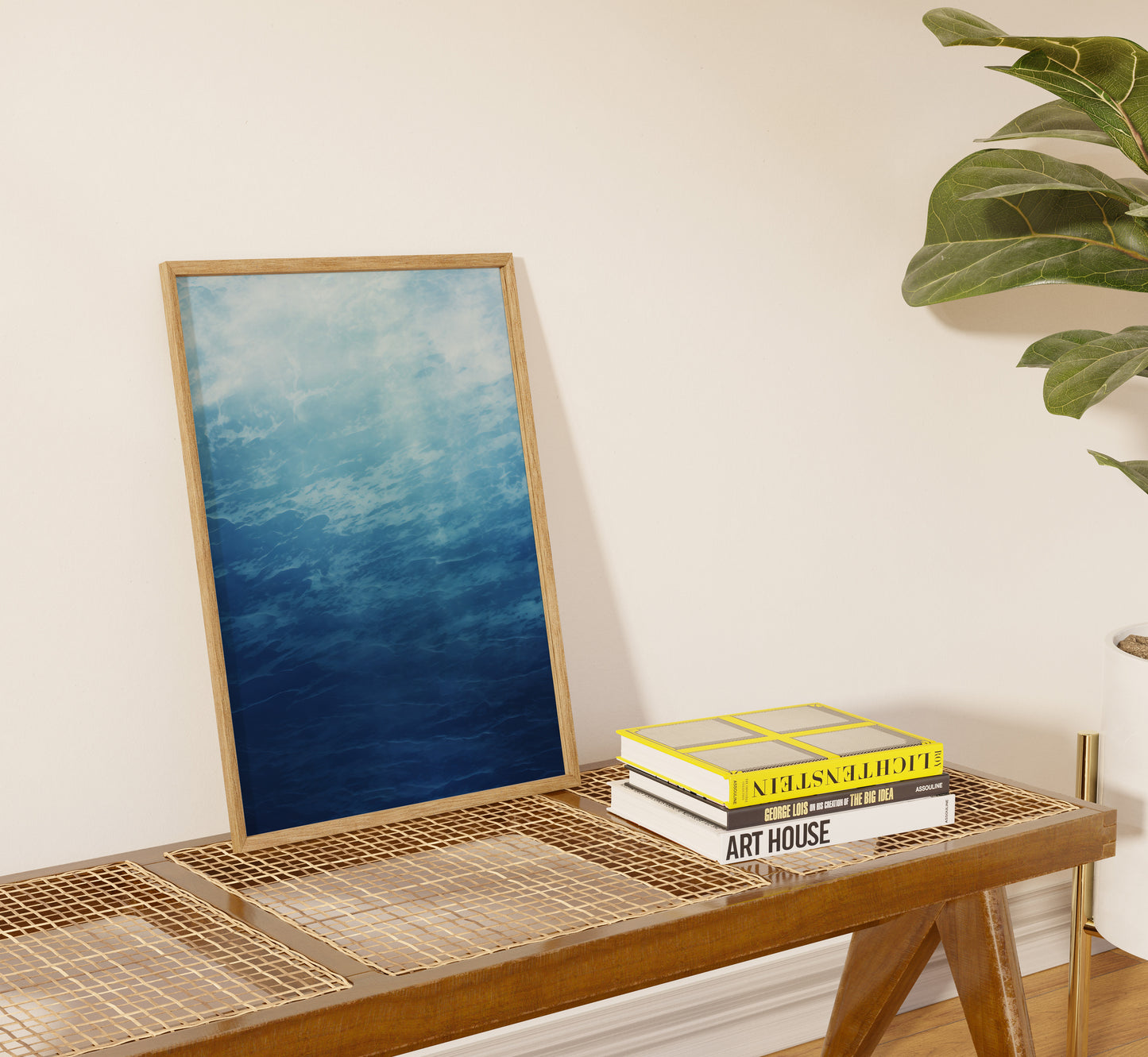 A blue abstract painting leaning against a wall on a shelf with books.