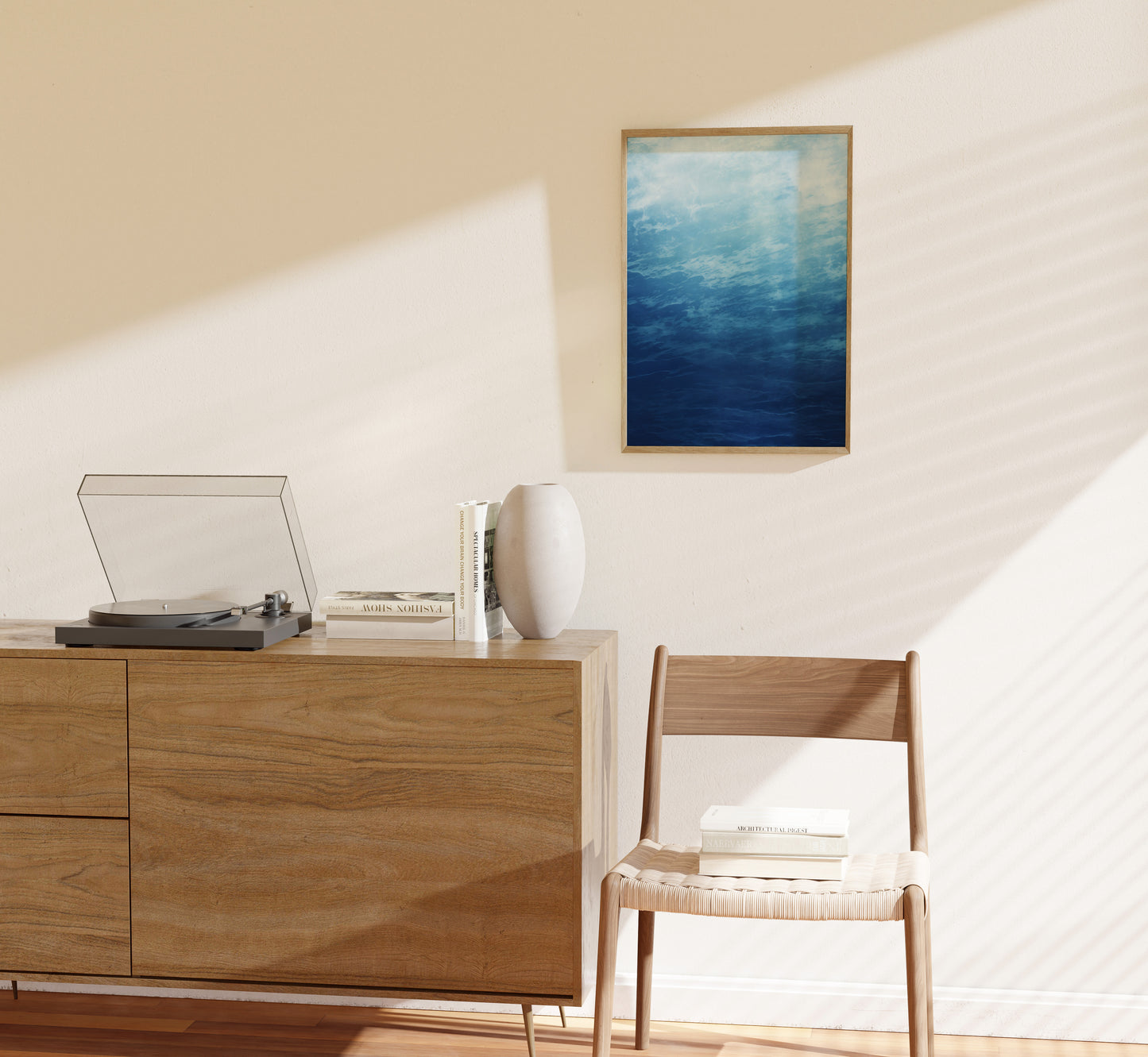 "Modern room with a wooden sideboard, turntable, white chair, books, and a blue abstract painting on the wall."