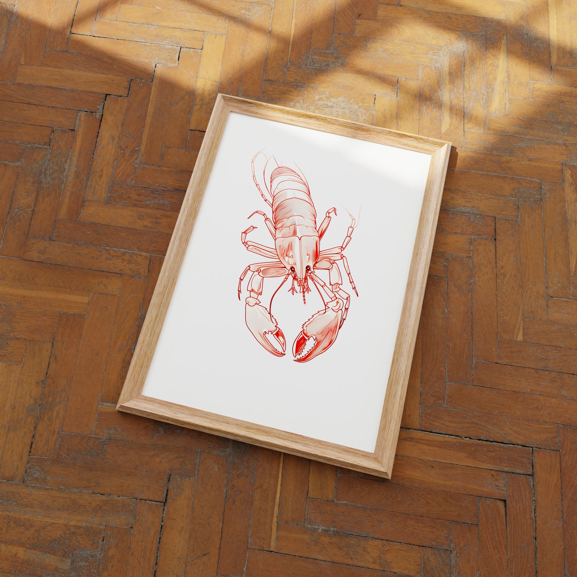 Framed illustration of a lobster on a wooden floor.