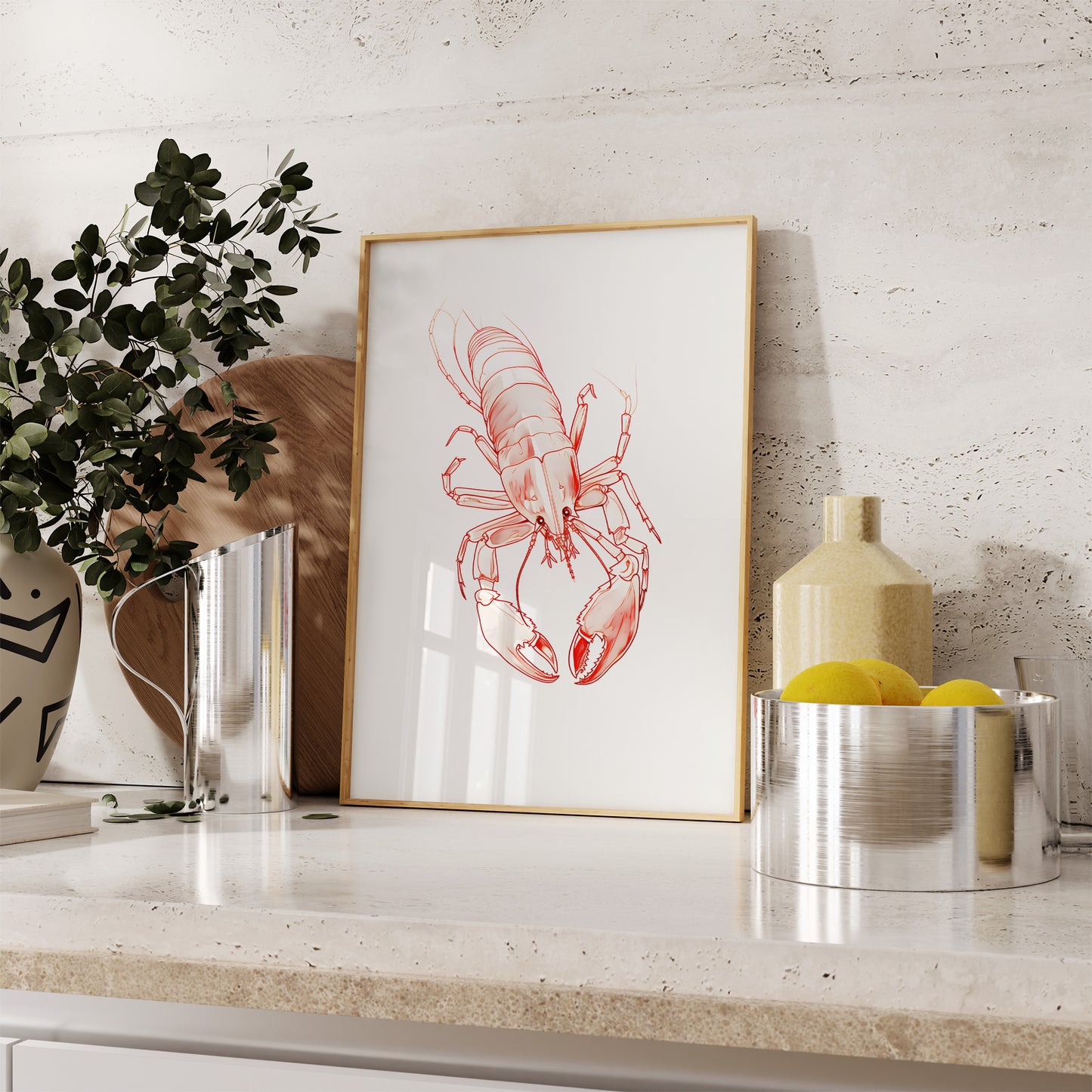 Framed lobster illustration on a kitchen counter with decorative items.